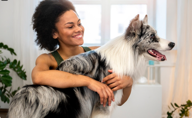 A woman carrying a dog